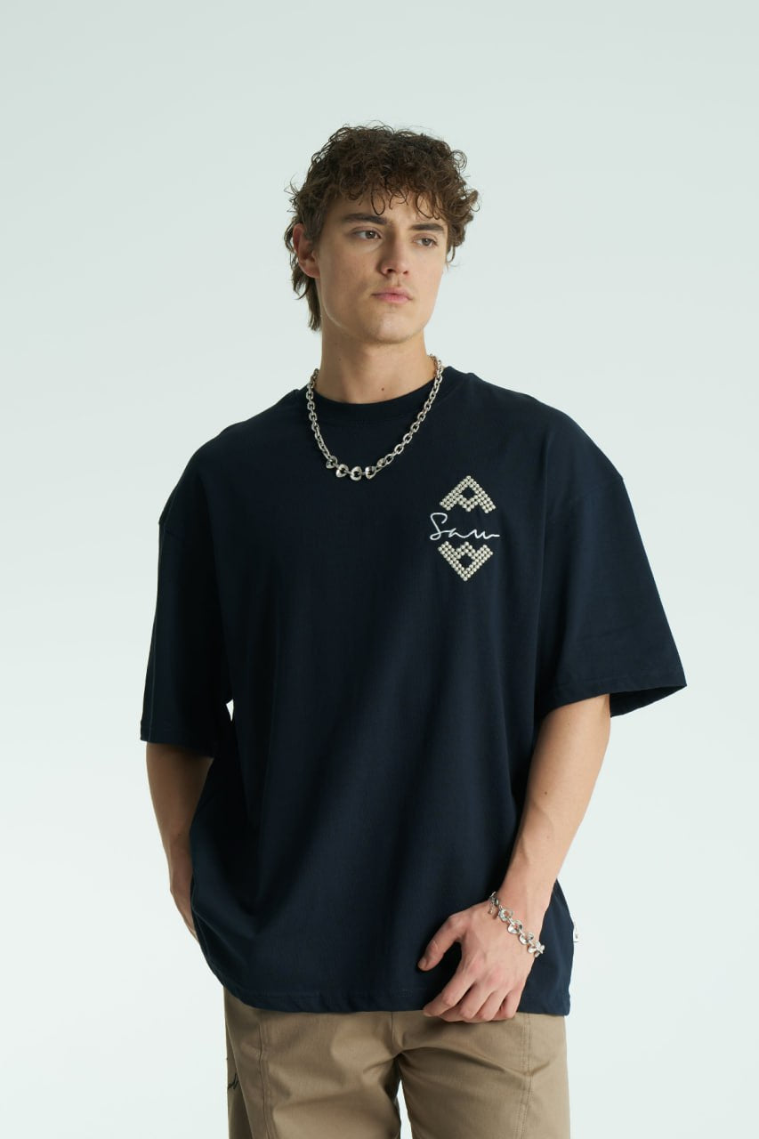 Navy Oversized Sam graphic T-shirt with ornate back print and rhinestone-style detailing, shown in white, black, brown and navy