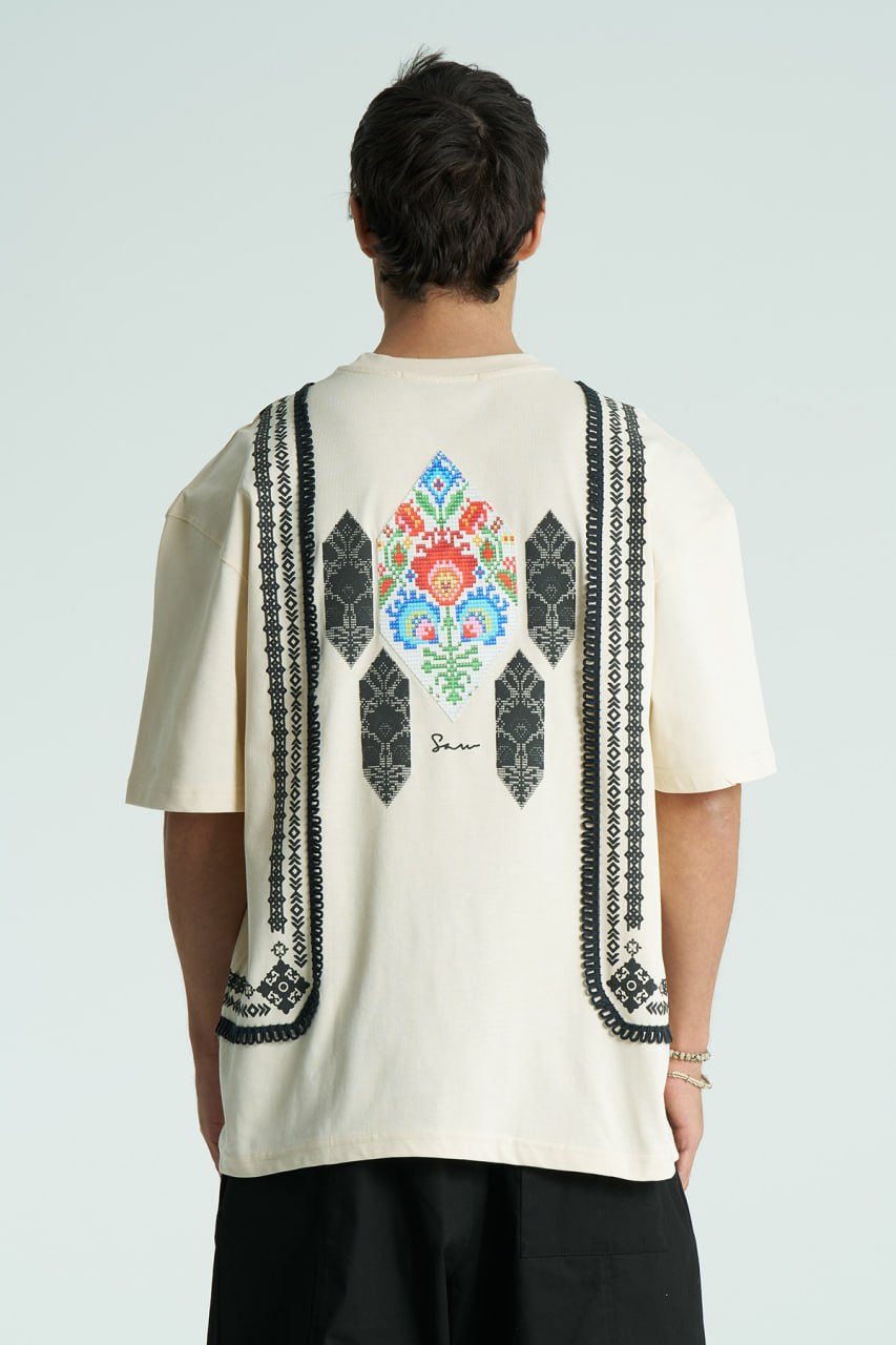 Cream Sam oversized crewneck graphic T-shirt with embroidered motif and ornate border trims in black, cream, and white colorways