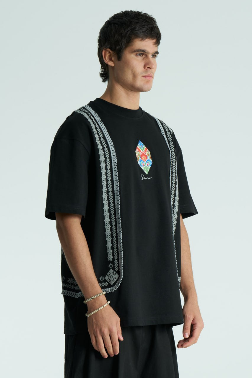 Black Sam oversized crewneck graphic T-shirt with embroidered motif and ornate border trims in black, cream, and white colorways