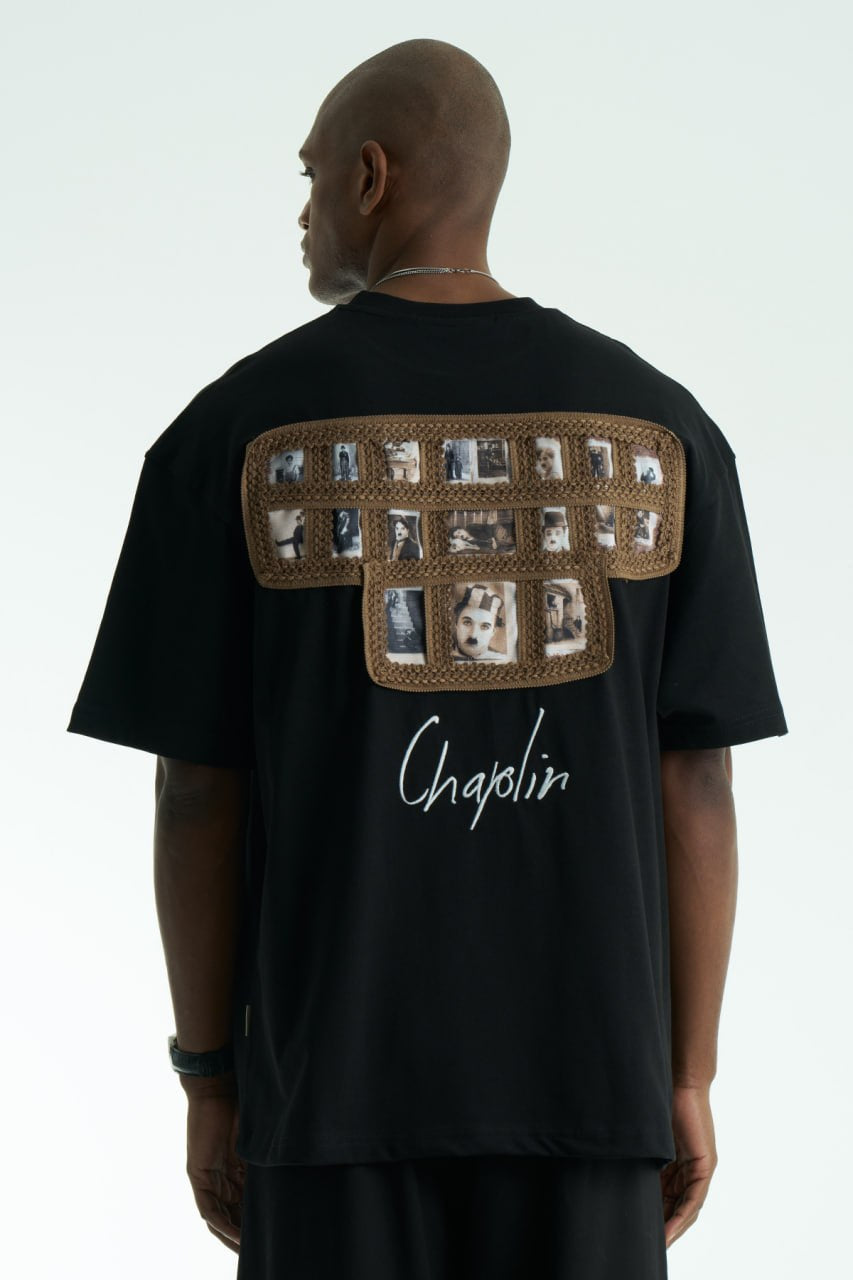 Black Chaplin oversized cotton graphic T-shirt with front script logo and collage patch back, shown in black and white