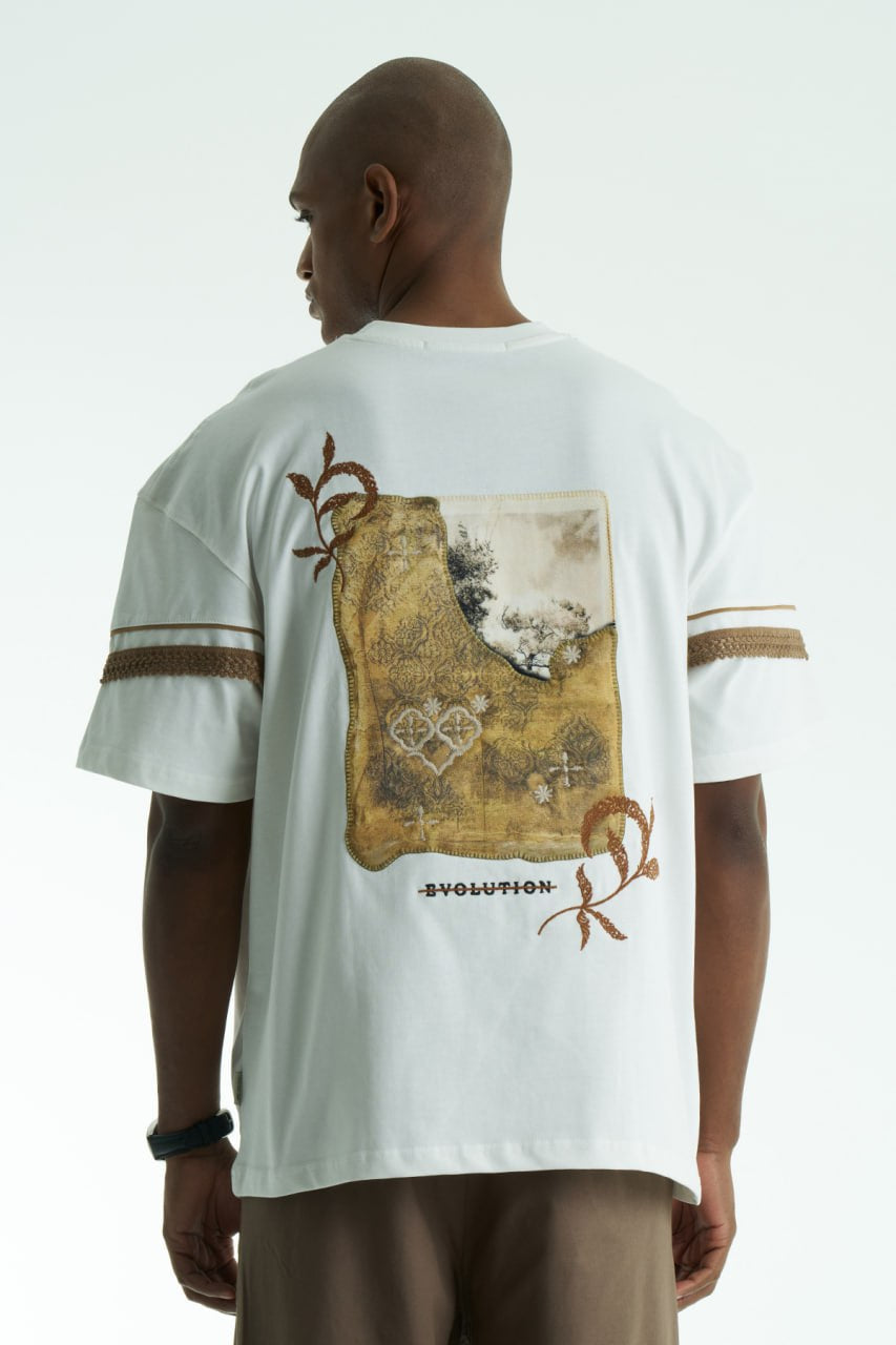 White Evolution oversized crewneck graphic T-shirt with sleeve trim and ornate back print in black, white, navy, and cream