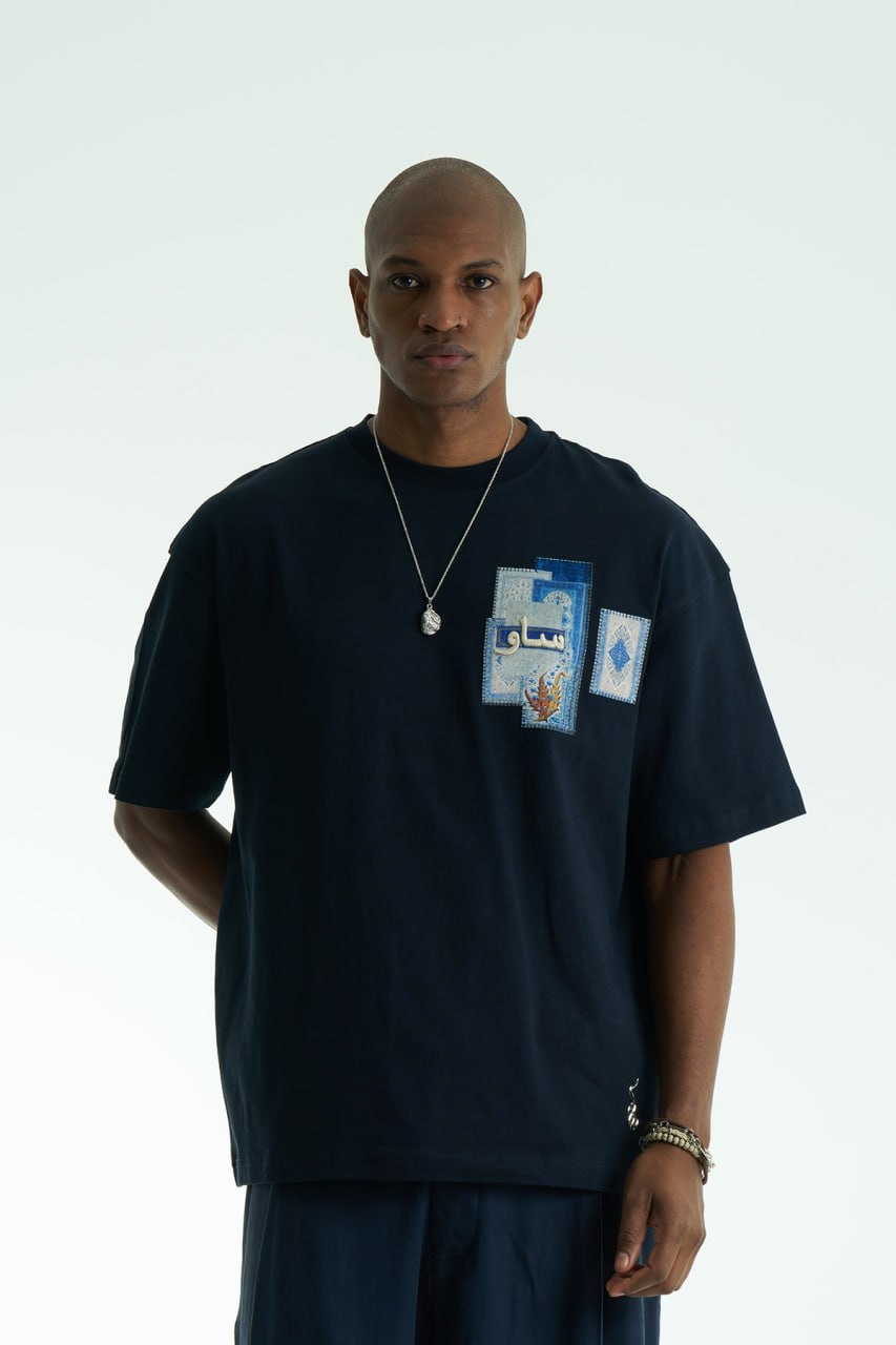 Navy Oversized SAVO graphic cotton T-shirt with small chest print and large blue tile-collage back print, shown in multiple colors