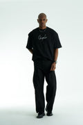 Black Chaplin oversized cotton graphic T-shirt with front script logo and collage patch back, shown in black and white