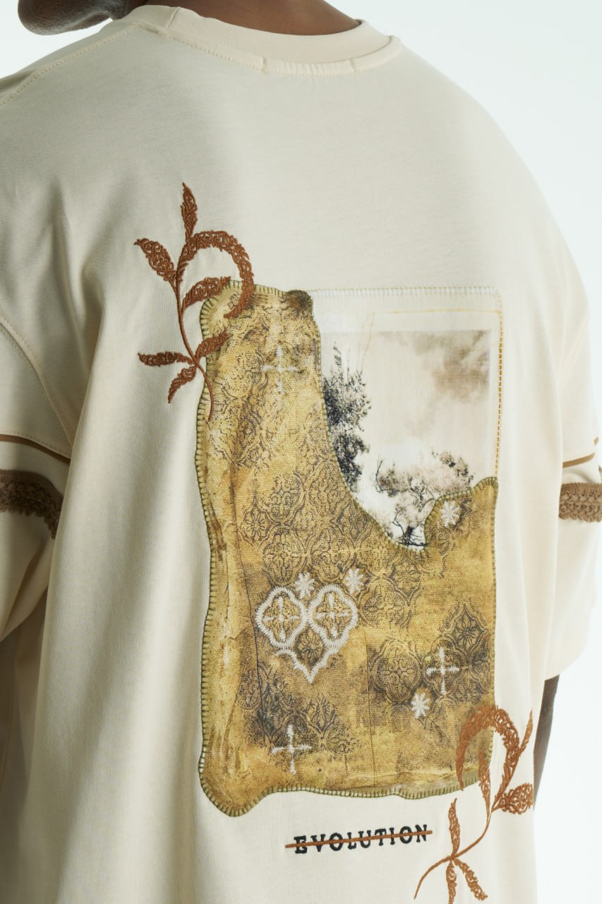Cream Evolution oversized crewneck graphic T-shirt with sleeve trim and ornate back print in black, white, navy, and cream