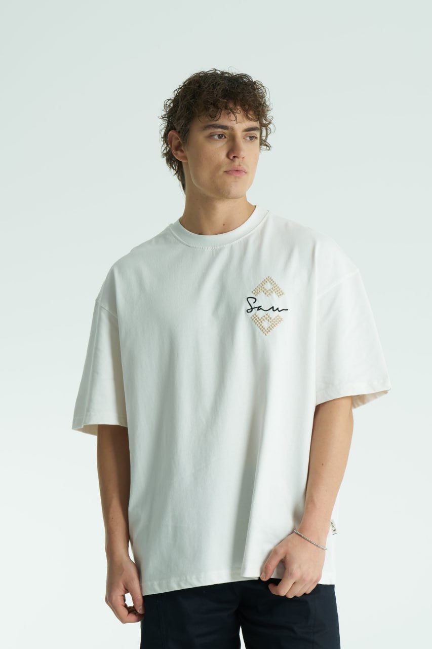 White Oversized Sam graphic T-shirt with ornate back print and rhinestone-style detailing, shown in white, black, brown and navy