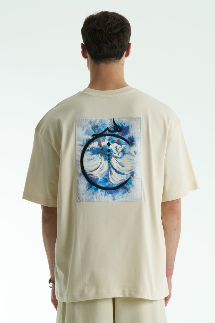 Cream Oversized cotton graphic T-shirt with minimalist chest logo and stitched back artwork patch, shown in multiple colorways on model