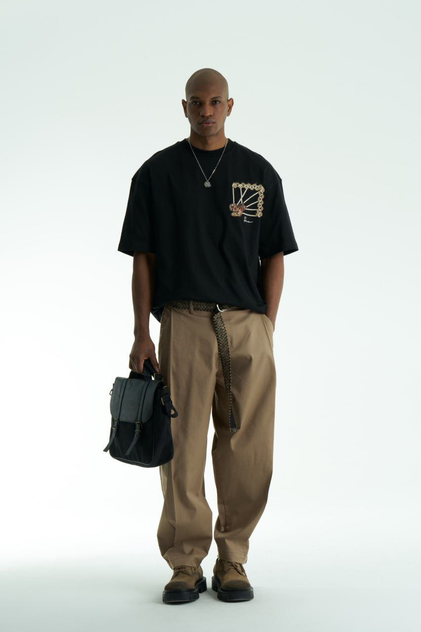 Black Senu oversized crewneck graphic T-shirt with rope-frame tapestry emblem, shown in black, white, brown and navy with front and back views
