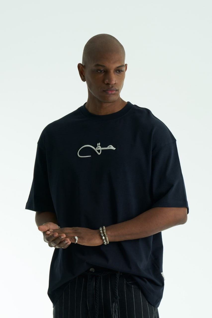 Navy Oversized Haqi crewneck graphic T-shirt with calligraphy chest logo and large back rug-print panel in multiple colors