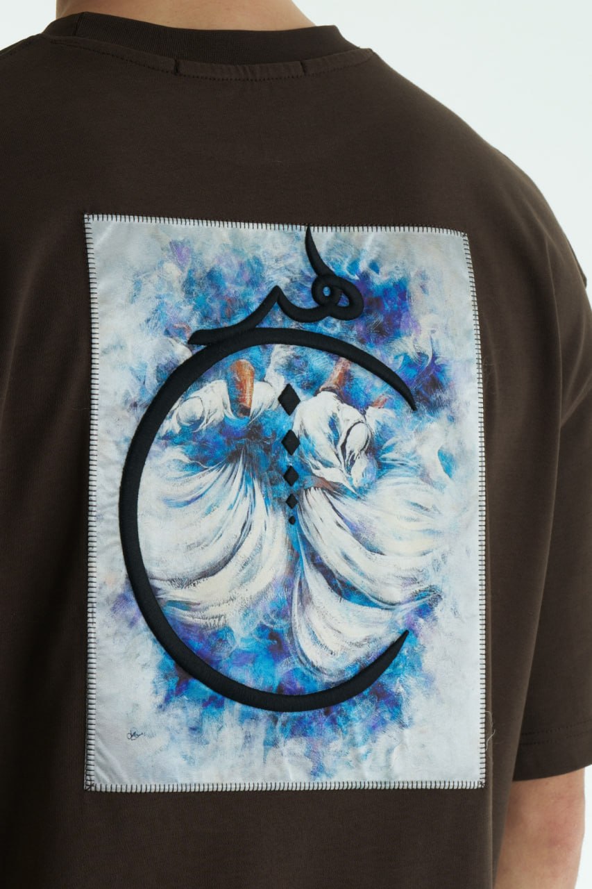 Dark Brown Oversized cotton graphic T-shirt with minimalist chest logo and stitched back artwork patch, shown in multiple colorways on model