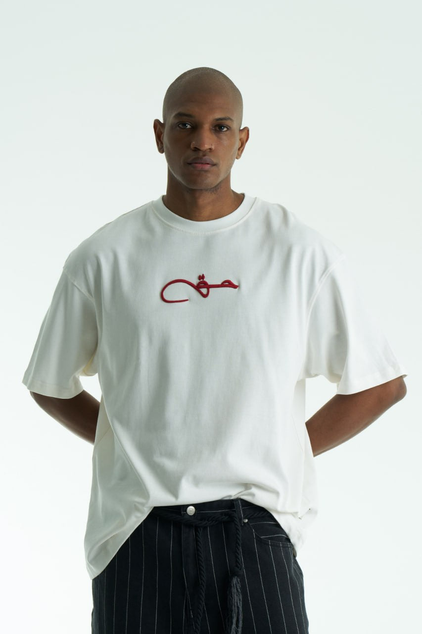 White Oversized Haqi crewneck graphic T-shirt with calligraphy chest logo and large back rug-print panel in multiple colors