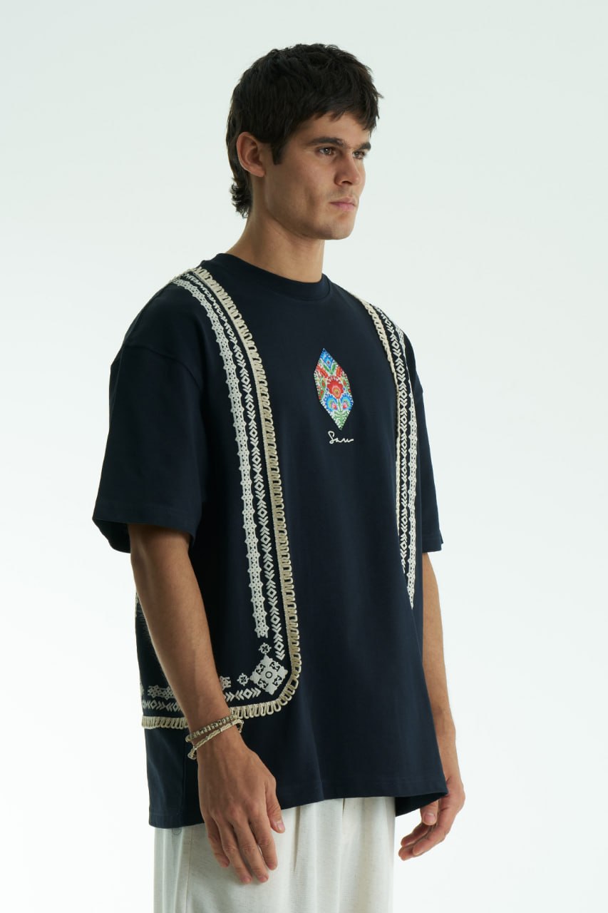Navy Sam oversized crewneck graphic T-shirt with embroidered motif and ornate border trims in black, cream, and white colorways