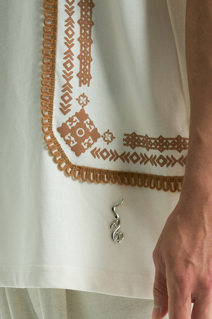 White Sam oversized crewneck graphic T-shirt with embroidered motif and ornate border trims in black, cream, and white colorways