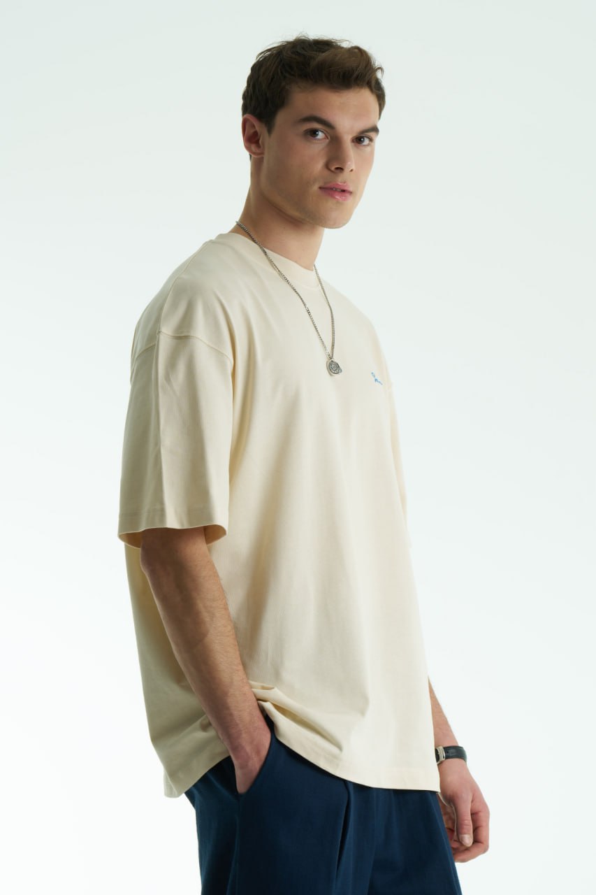 Cream Son oversized crewneck graphic T-shirt with small chest logo and large tapestry-style back print, shown in brown, cream, and black