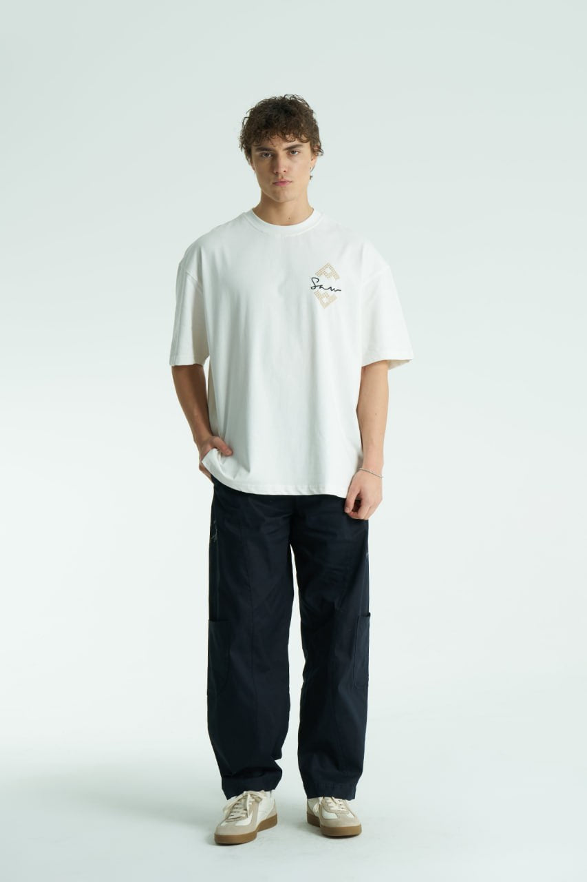 White Oversized Sam graphic T-shirt with ornate back print and rhinestone-style detailing, shown in white, black, brown and navy