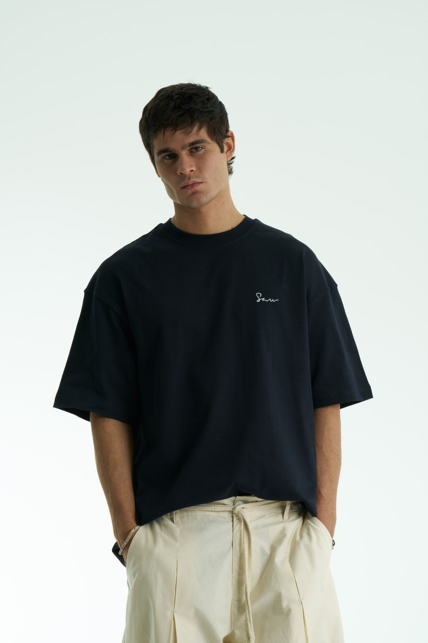 Black Oversized Sons crew-neck T-shirt with chest script logo and ornate fringed back patch, shown in black and white