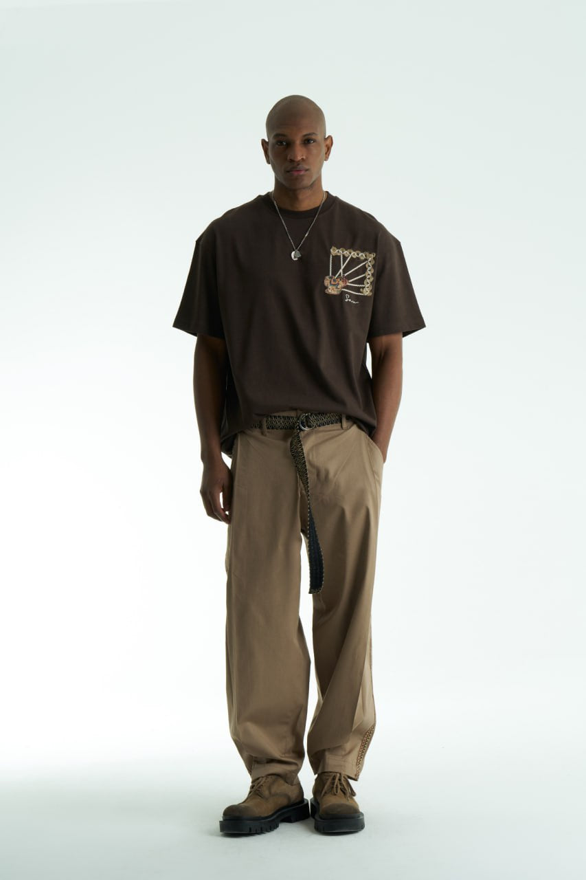 Brown Senu oversized crewneck graphic T-shirt with rope-frame tapestry emblem, shown in black, white, brown and navy with front and back views