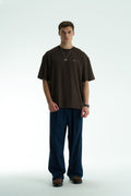 Brown Son oversized crewneck graphic T-shirt with small chest logo and large tapestry-style back print, shown in brown, cream, and black