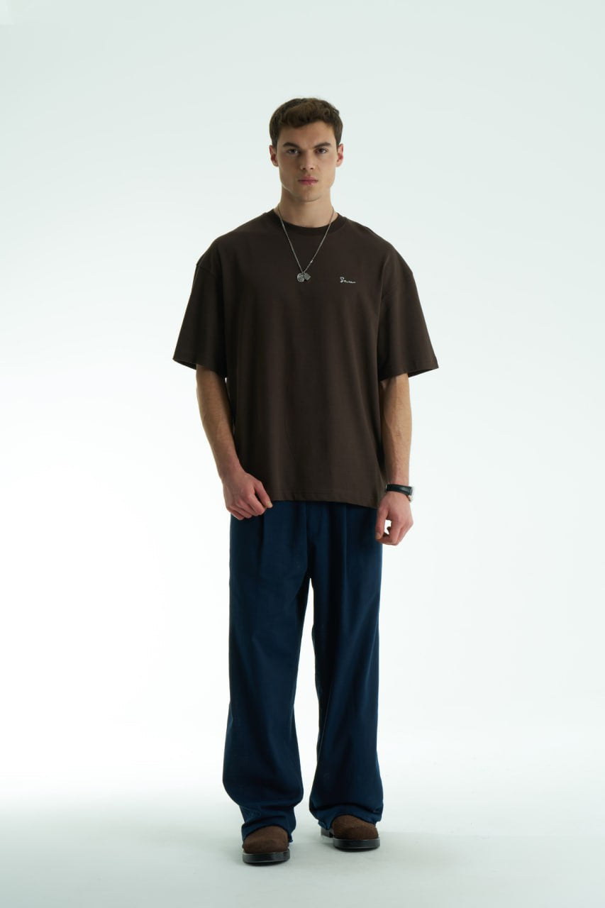 Brown Son oversized crewneck graphic T-shirt with small chest logo and large tapestry-style back print, shown in brown, cream, and black