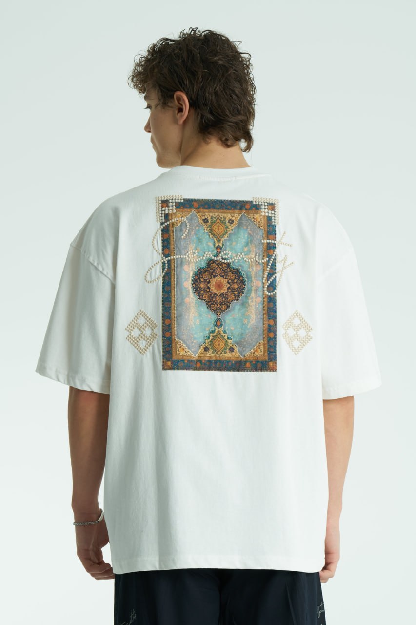 White Oversized Sam graphic T-shirt with ornate back print and rhinestone-style detailing, shown in white, black, brown and navy