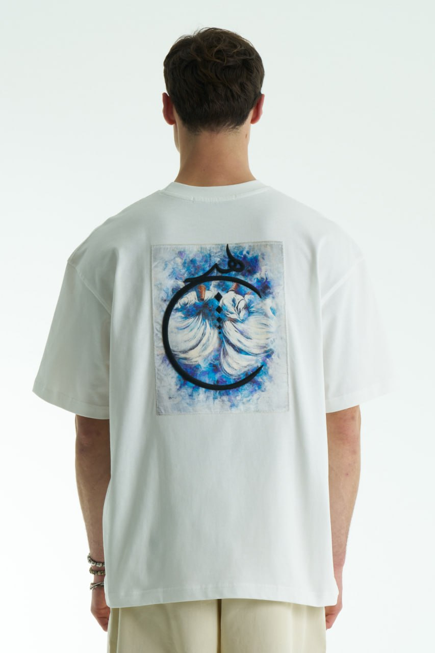 White Oversized cotton graphic T-shirt with minimalist chest logo and stitched back artwork patch, shown in multiple colorways on model