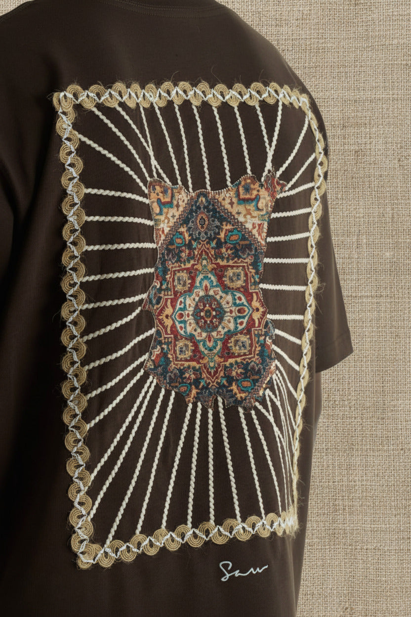 Brown Senu oversized crewneck graphic T-shirt with rope-frame tapestry emblem, shown in black, white, brown and navy with front and back views