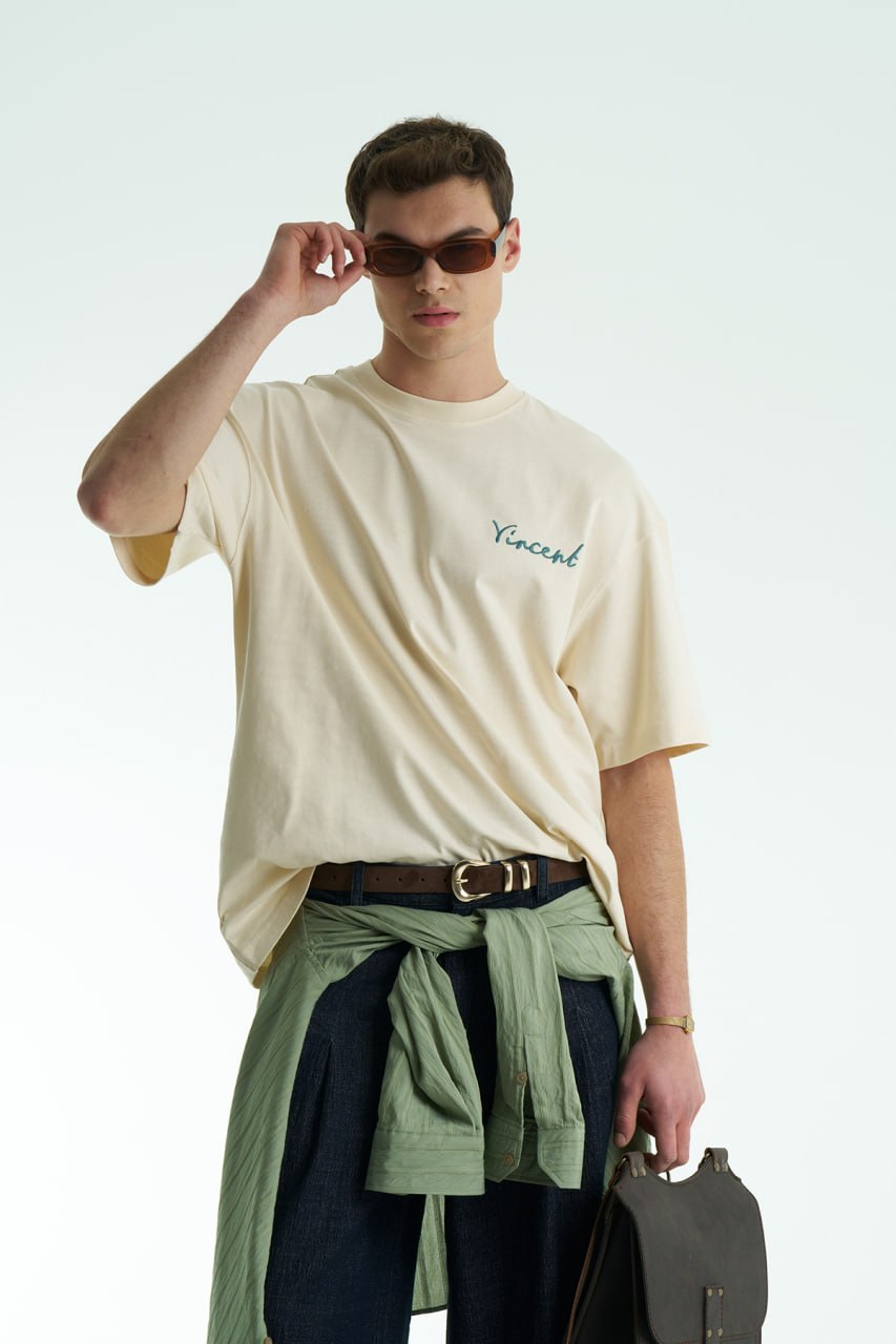 Cream Vincent oversized crewneck graphic T-shirt with small chest logo and large illustrated back print, shown in black, white and cream.