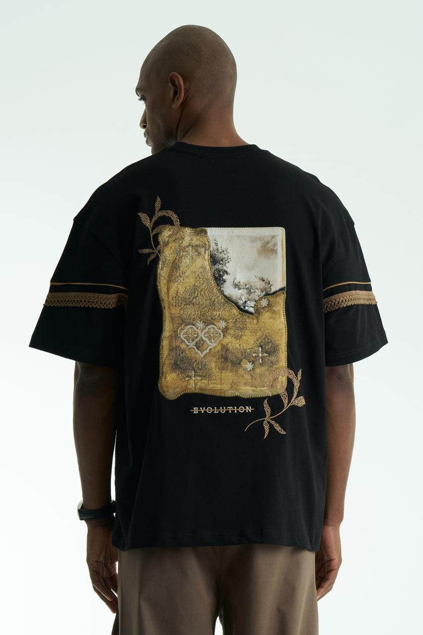 Black Evolution oversized crewneck graphic T-shirt with sleeve trim and ornate back print in black, white, navy, and cream