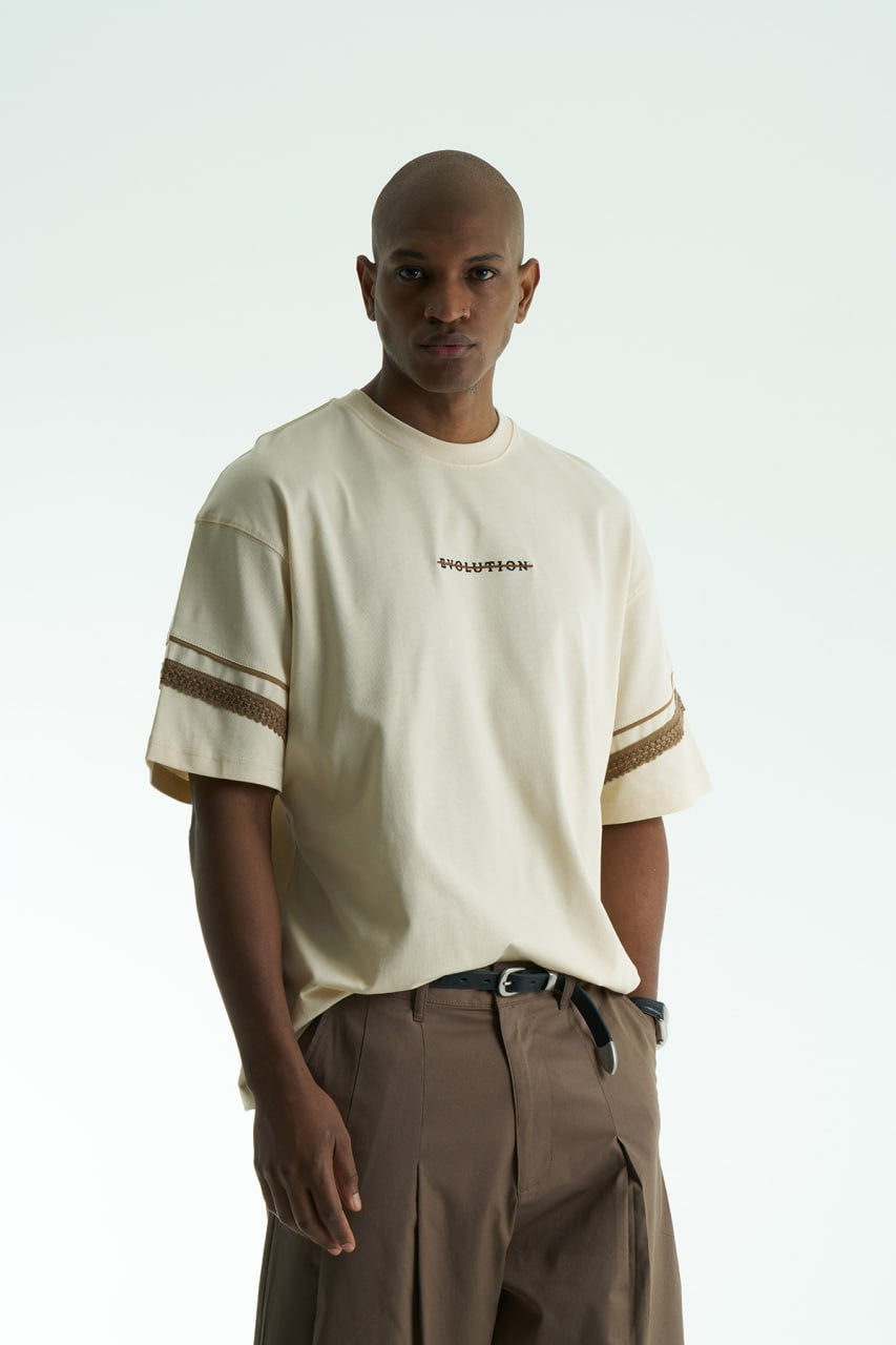 Cream Evolution oversized crewneck graphic T-shirt with sleeve trim and ornate back print in black, white, navy, and cream