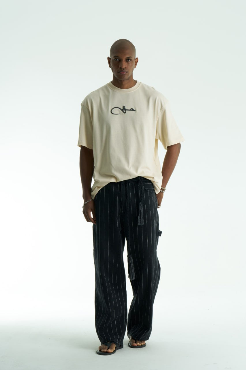 Cream Oversized Haqi crewneck graphic T-shirt with calligraphy chest logo and large back rug-print panel in multiple colors