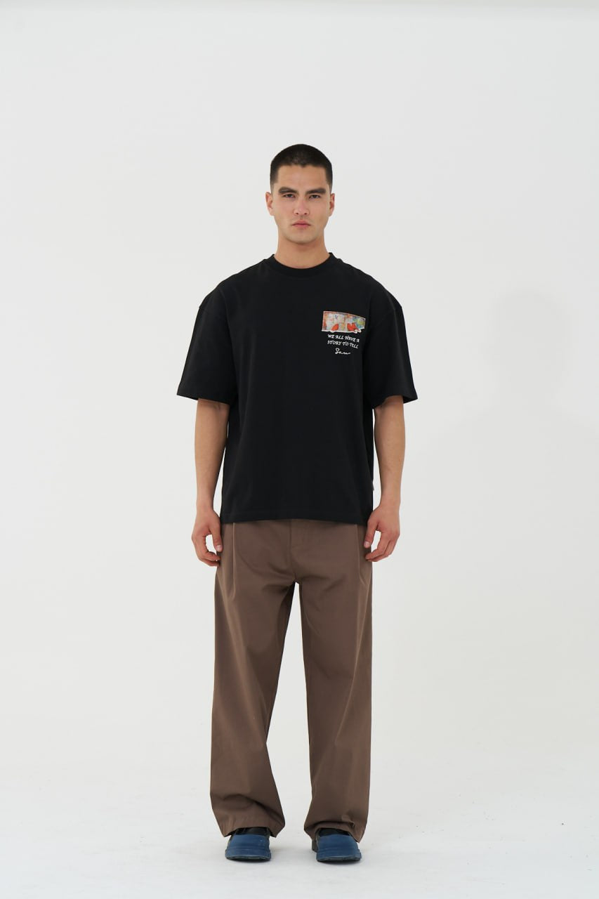Black Oversized Graphic T-Shirt with “We All Have Stories to Tell” Back Print