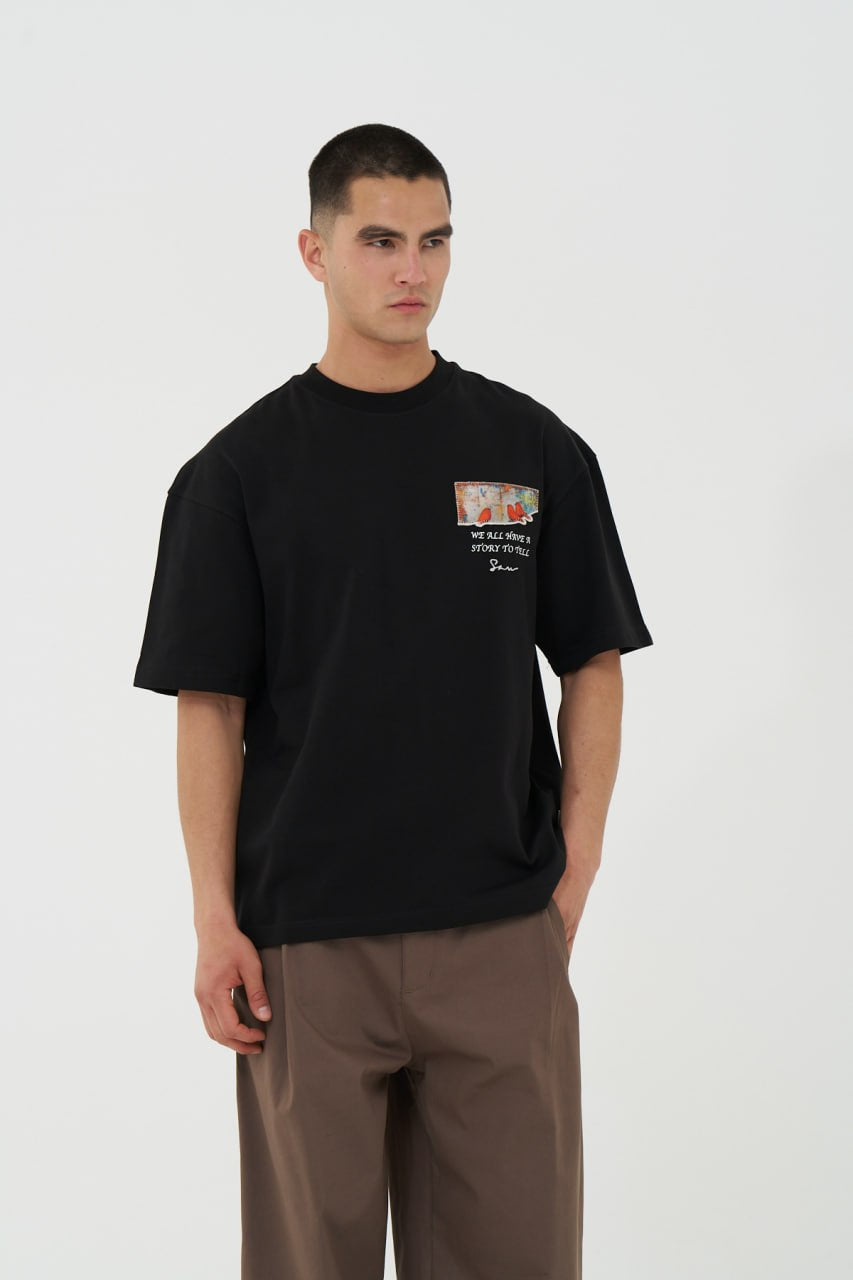 Black Oversized Graphic T-Shirt with “We All Have Stories to Tell” Back Print