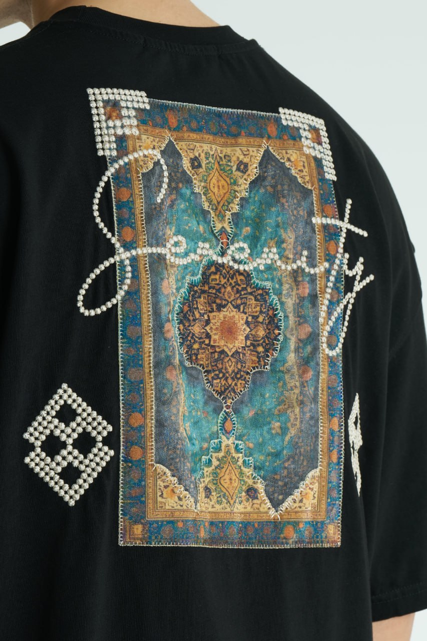 Black Oversized Sam graphic T-shirt with ornate back print and rhinestone-style detailing, shown in white, black, brown and navy