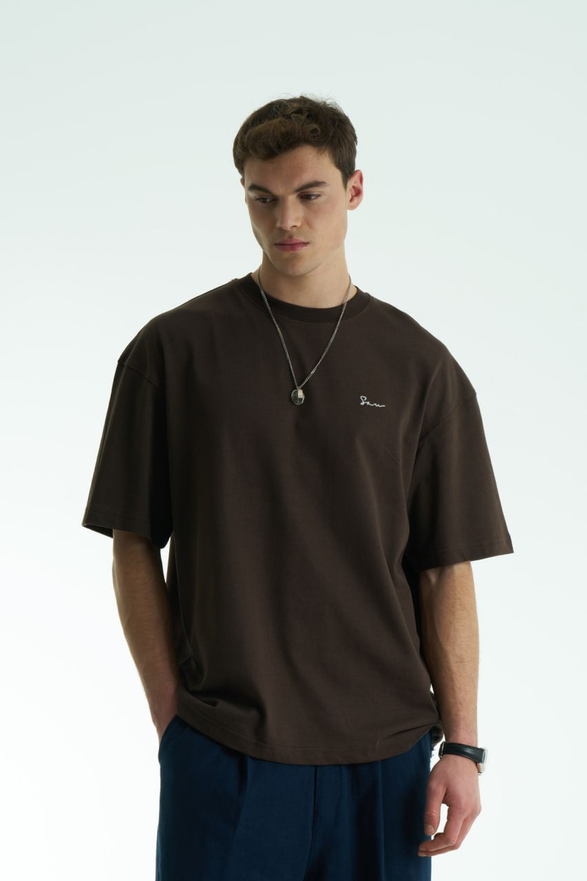 Brown Son oversized crewneck graphic T-shirt with small chest logo and large tapestry-style back print, shown in brown, cream, and black