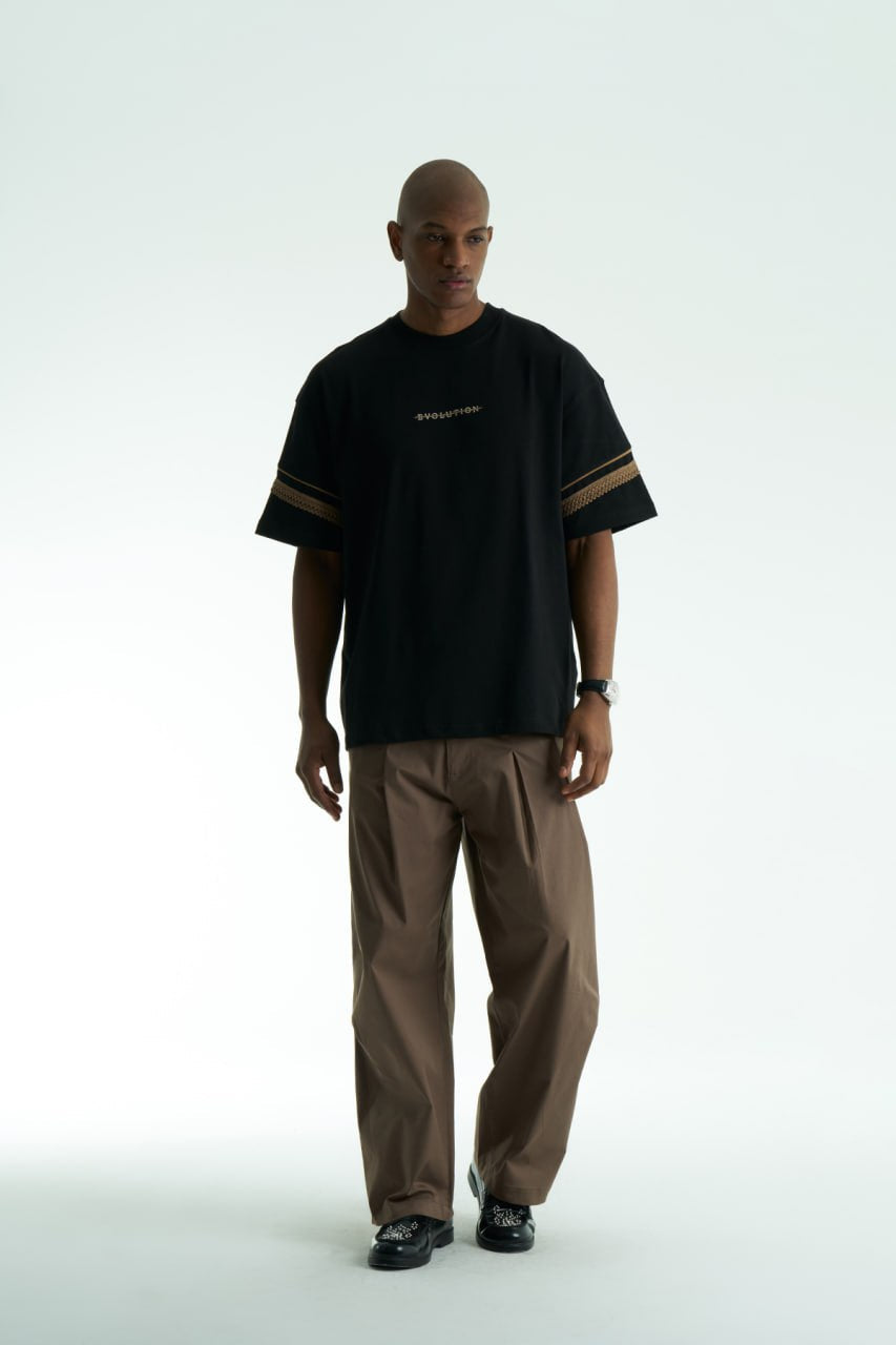 Black Evolution oversized crewneck graphic T-shirt with sleeve trim and ornate back print in black, white, navy, and cream