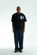 Black Oversized SAVO graphic cotton T-shirt with small chest print and large blue tile-collage back print, shown in multiple colors