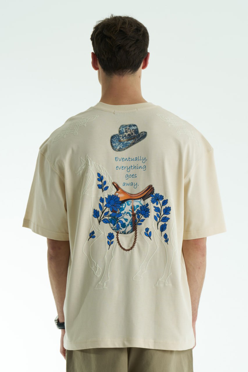 Cream Oversized graphic T-shirt with chest print and large back horse-and-hat artwork reading “Eventually, everything goes away.”