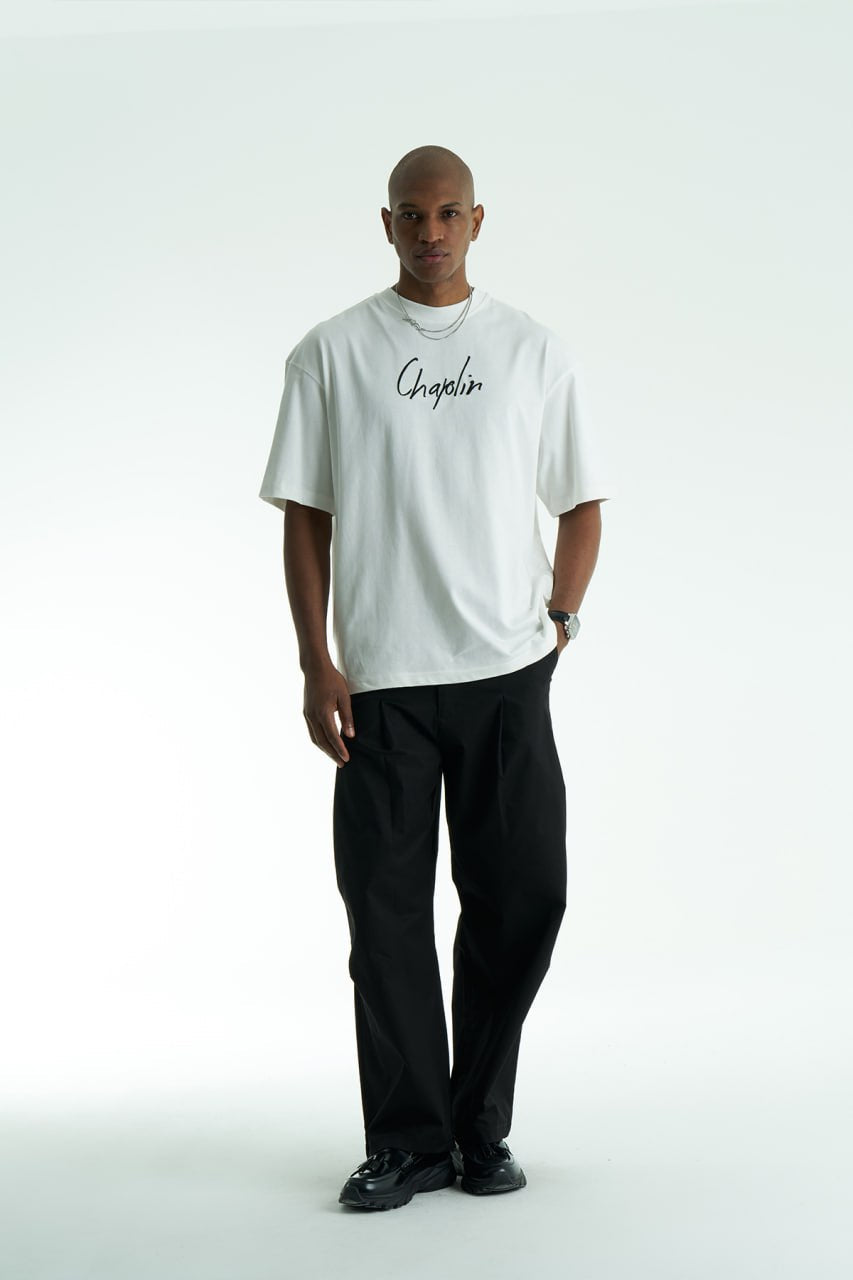 White Chaplin oversized cotton graphic T-shirt with front script logo and collage patch back, shown in black and white