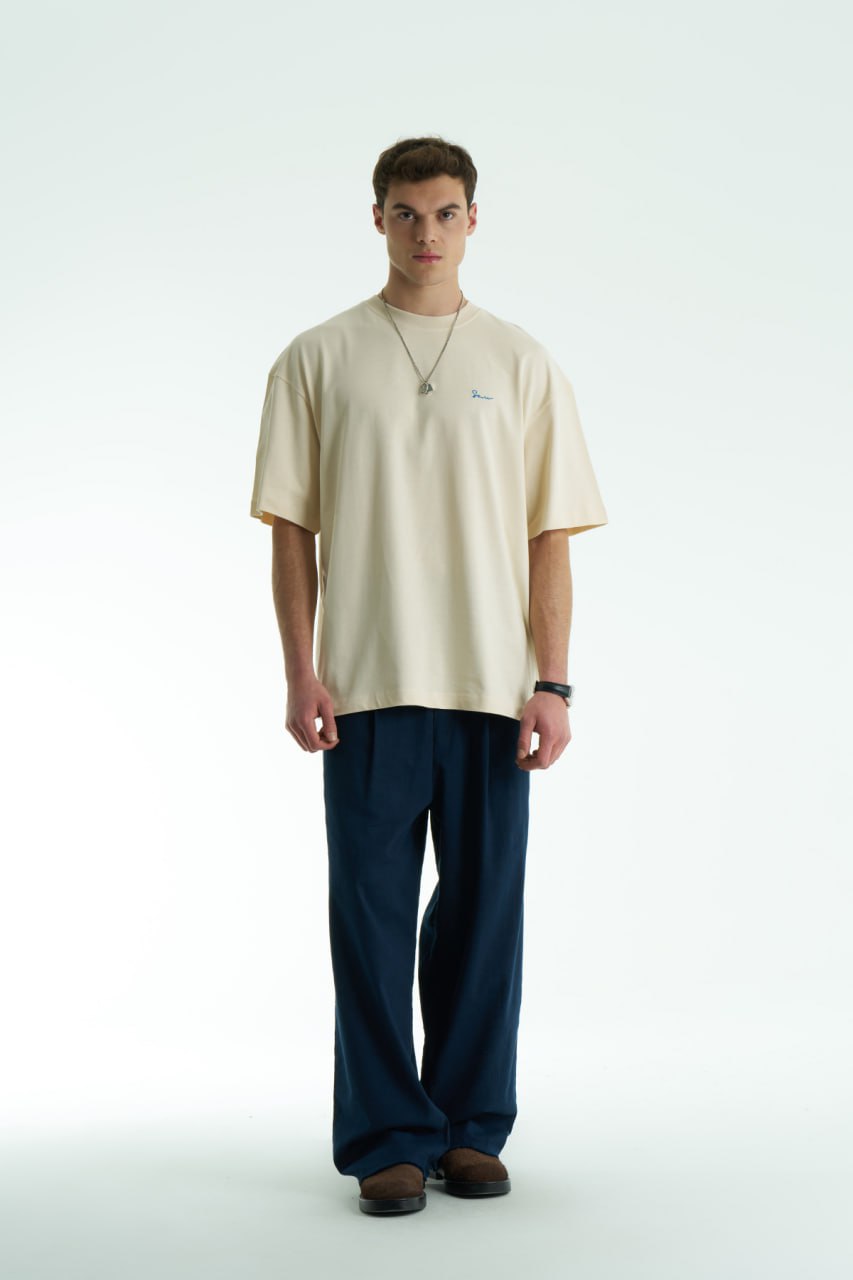 Cream Son oversized crewneck graphic T-shirt with small chest logo and large tapestry-style back print, shown in brown, cream, and black