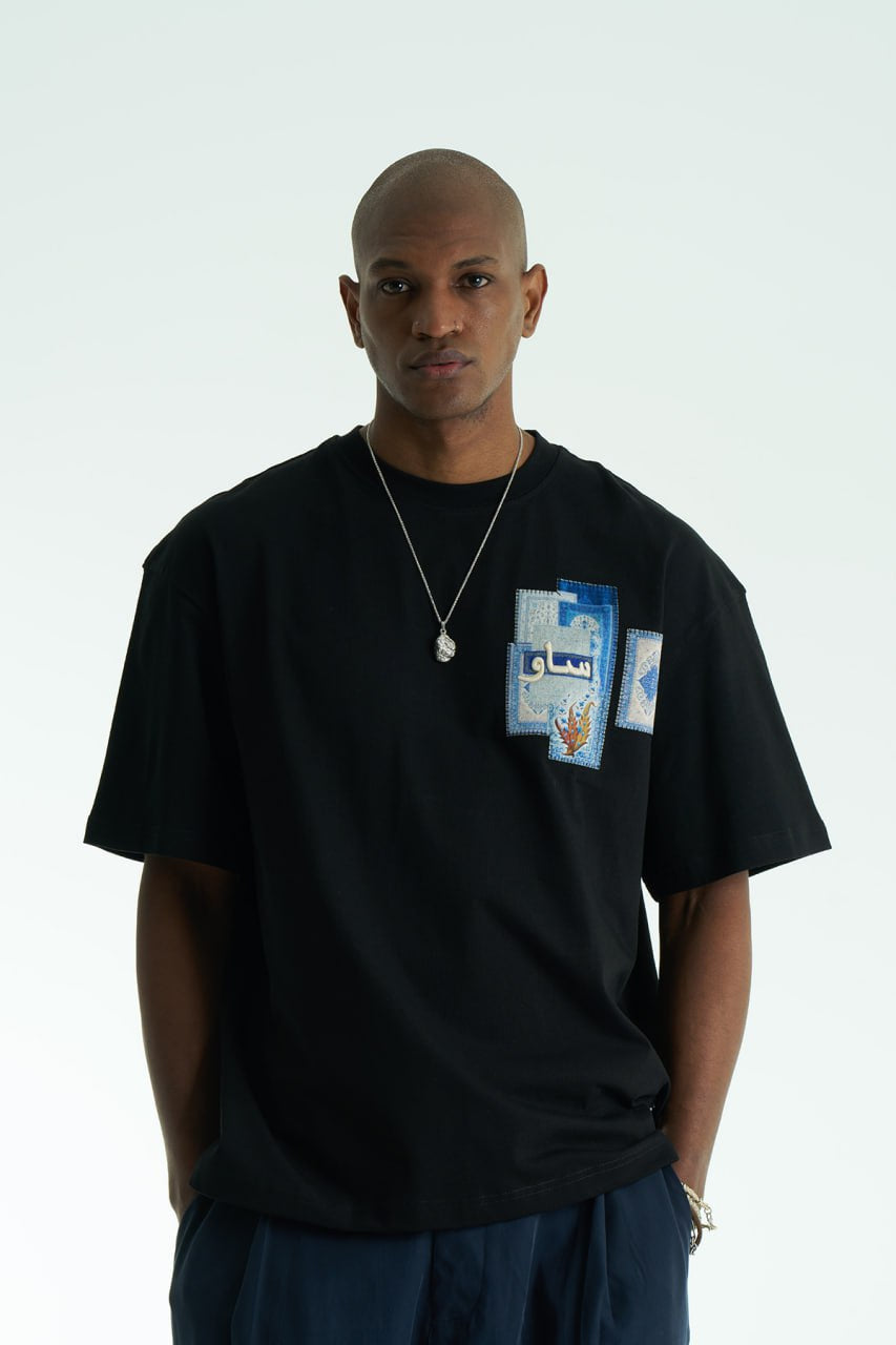 Black Oversized SAVO graphic cotton T-shirt with small chest print and large blue tile-collage back print, shown in multiple colors