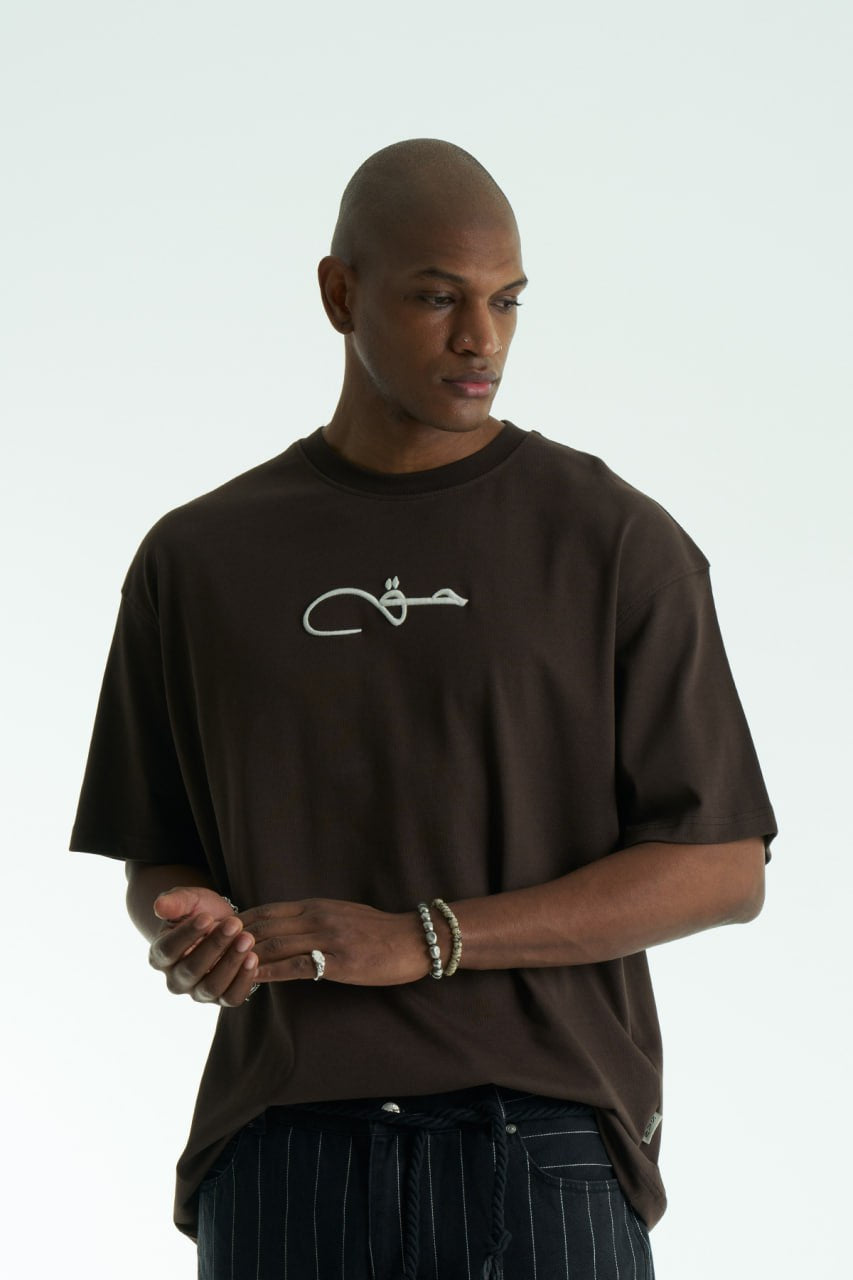 Dark Brown Oversized Haqi crewneck graphic T-shirt with calligraphy chest logo and large back rug-print panel in multiple colors