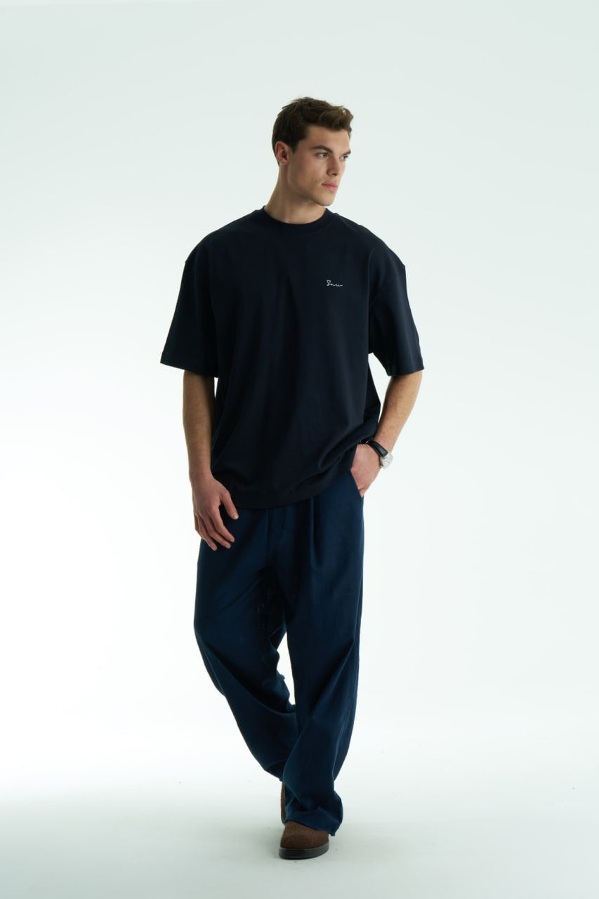 Black Son oversized crewneck graphic T-shirt with small chest logo and large tapestry-style back print, shown in brown, cream, and black