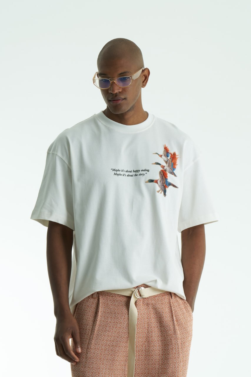 White Oversized cotton T-shirt with embroidered flying ducks and quote print, shown in multiple colorways front and back.