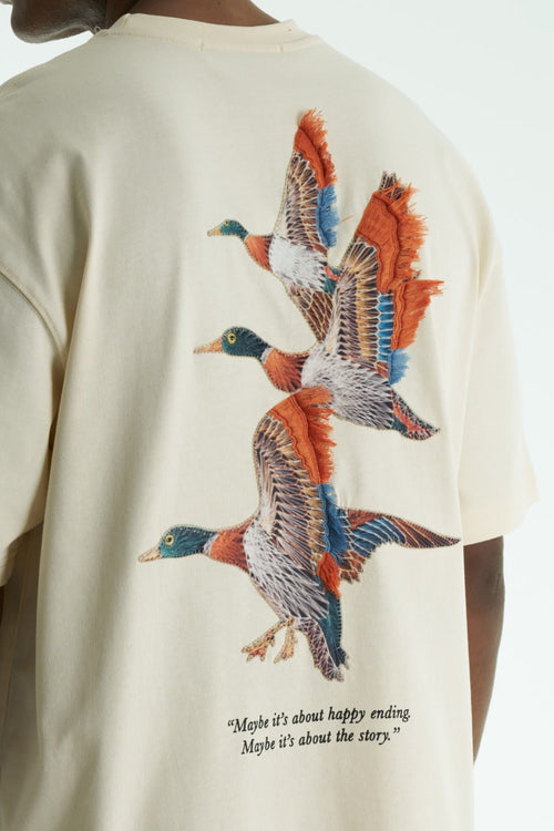 Beige Oversized cotton T-shirt with embroidered flying ducks and quote print, shown in multiple colorways front and back.