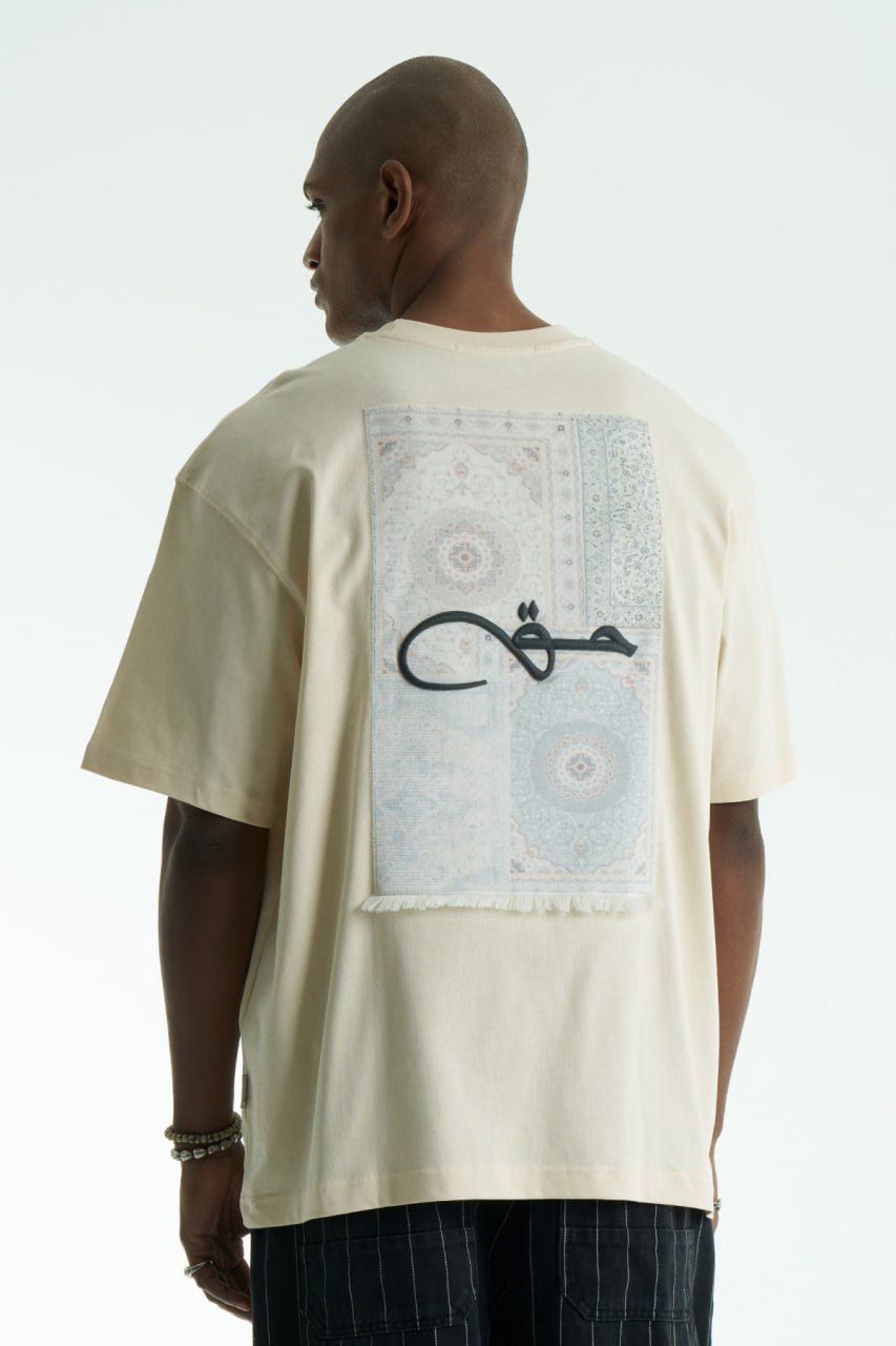 Cream Oversized Haqi crewneck graphic T-shirt with calligraphy chest logo and large back rug-print panel in multiple colors