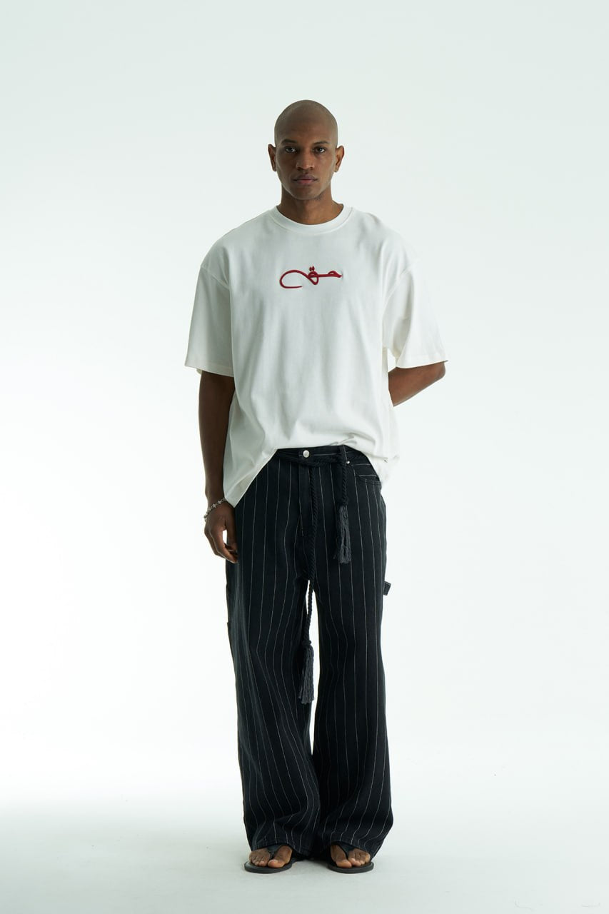 White Oversized Haqi crewneck graphic T-shirt with calligraphy chest logo and large back rug-print panel in multiple colors