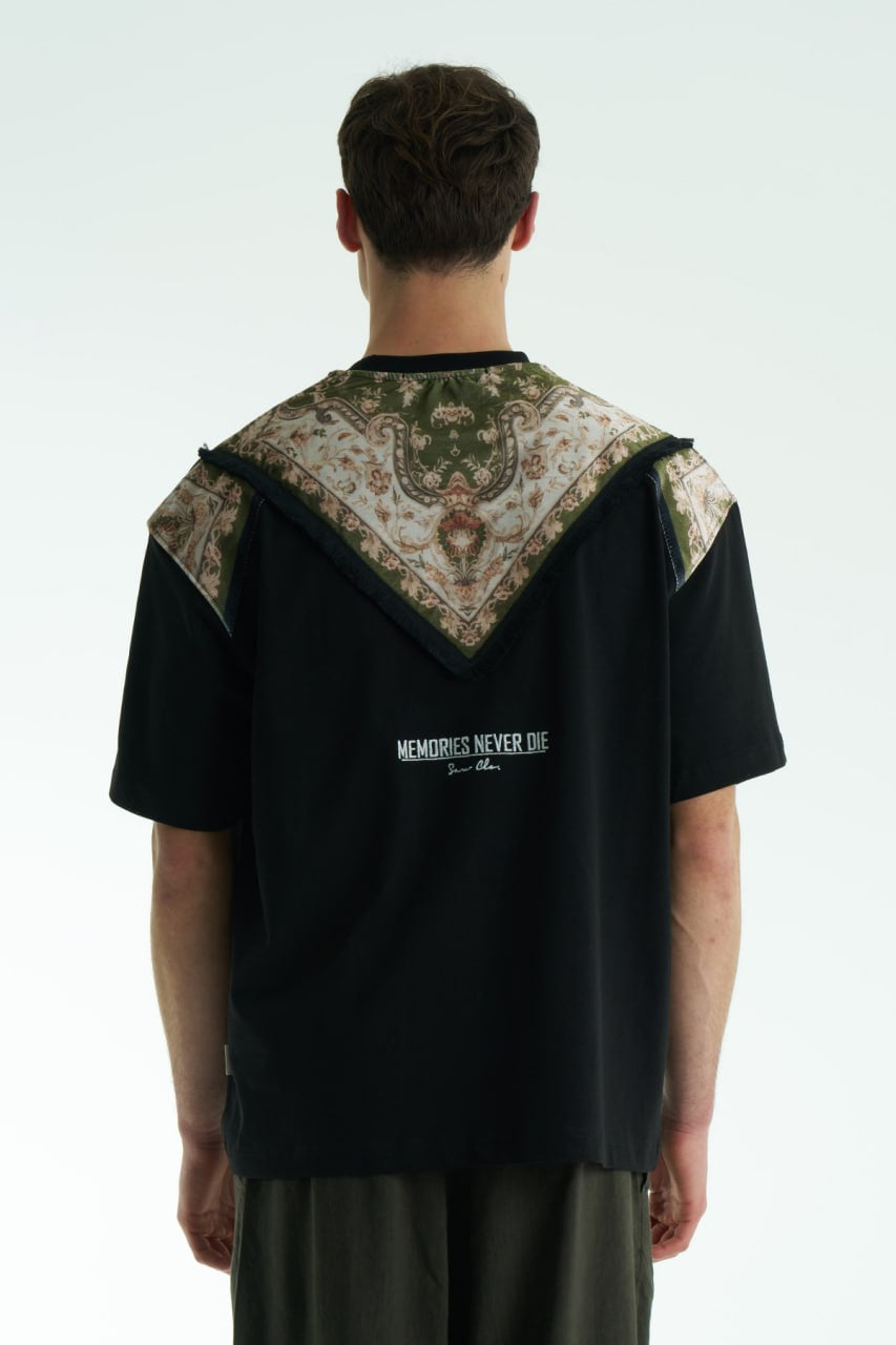 Black Oversized Memories Never Die cotton tee with chest pocket appliqué and scarf-style back yoke, shown in white, beige, and black.