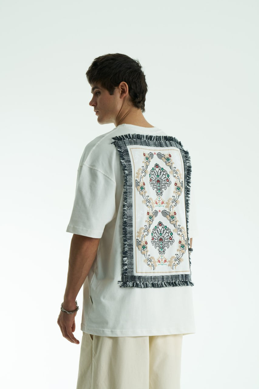 White Oversized Sons crew-neck T-shirt with chest script logo and ornate fringed back patch, shown in black and white