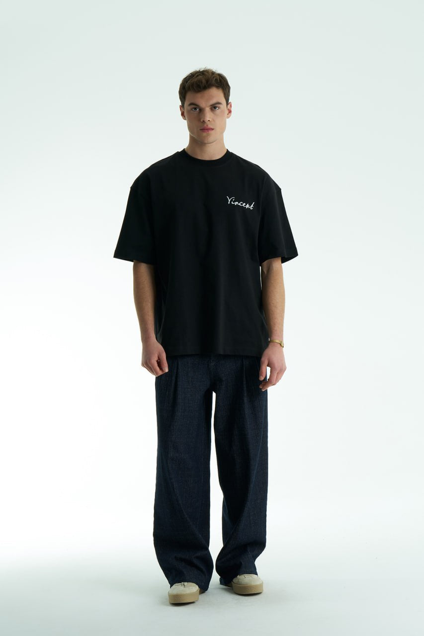 Black Vincent oversized crewneck graphic T-shirt with small chest logo and large illustrated back print, shown in black, white and cream.